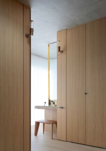 A modern interior design featuring a dresser station with a wooden finish, minimalist design, and a clean, spacious layout.
