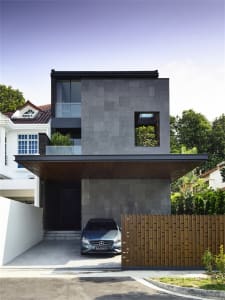 Modern architectural design featuring a contemporary residential house with concrete exterior and large windows.