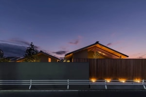 A minimalist house with wooden exterior at dusk.