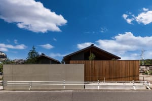 Modern residential exterior featuring wood materials and a gabled roof.