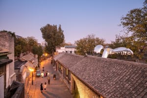 An image depicting a street view with tiled roofs.