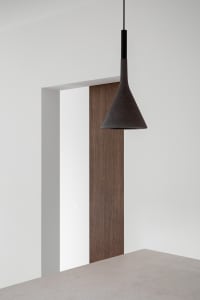 A minimalist interior design featuring a wooden panel.