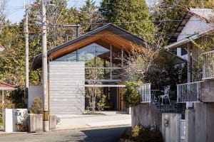 A modern house with a combination of concrete and glass exterior materials.