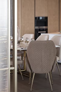 Modern marble dining room with elegant chairs and table centerpiece.