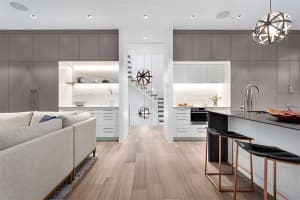 Modern kitchen and living room with minimalist design and open concept layout.