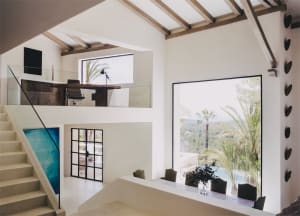 Modern residential interior with concrete, wood, and glass elements.