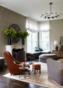 A living room with a modern design, featuring leather furniture, large windows, and a cozy seating area.
