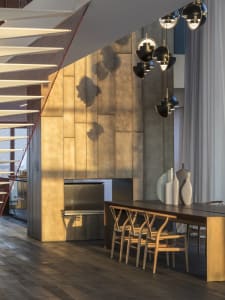 Modern dining room with geometric lighting fixtures and metallic walls