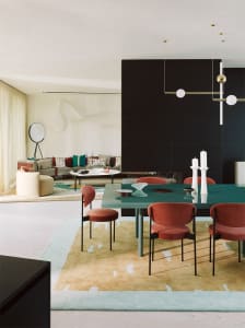 Modern living room and dining area with contemporary furniture and colorful accents.