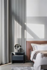 Contemporary bedroom featuring a textured wall and minimalist design elements.