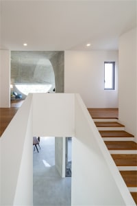 Clean, minimalist residential interior with concrete and wood elements.