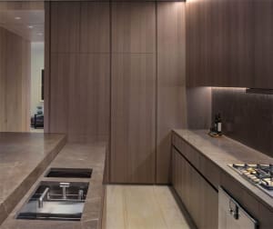 Modern kitchen featuring marble countertops and backsplash