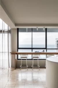 A modern interior design featuring wood, glass, and metal materials.