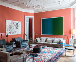 A modern living room featuring sofas and vibrant wall colors.