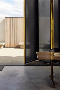 An industrial-style interior with wooden panels, metallic accents, and concrete flooring.