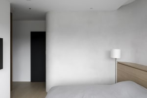 Minimalist bedroom featuring concrete walls and floor, simplicity and modernity
