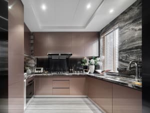Modern kitchen with marble countertops and wooden cabinets.