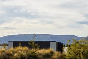 A modern residential home with minimalist design and mixed materials.