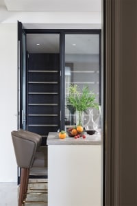 Modern minimalist kitchen with glass cabinets, featuring a sleek design and contemporary style.