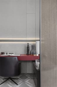 A modern home office featuring a sleek metallic red desk in a minimalist design setting.