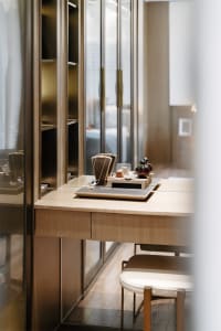 Modern vanity table with a wood finish, showcasing sleek design with minimalistic elements.
