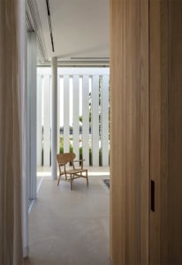 Modern interior design featuring wooden furniture and beige flooring.