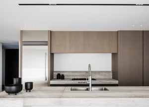 Modern kitchen interior featuring stone material and green accents