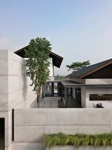 Modern architecture with concrete exterior and large windows.