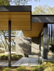 A modern entryway featuring wood and concrete materials.