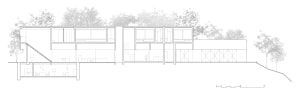 Modern residential facility with glass walls and concrete structural elements.