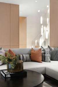 Modern minimalist living room featuring neutral-toned furniture and decor.