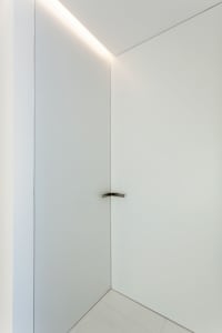 Modern minimalist interior with white walls and ceiling light fixture