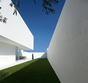 A modern exterior of a building with a minimalist design and concrete materials.