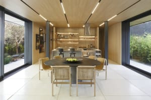 A modern kitchen and dining room featuring wood and metal elements.
