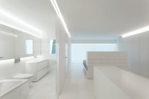 A modern minimalist bathroom with white tiles and construction.