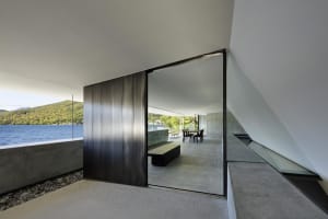 Modern residential interior with concrete and glass materials.