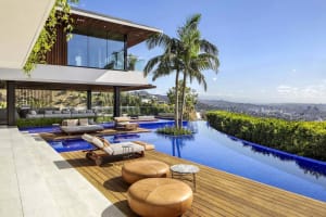 Modern residential architecture with a swimming pool and outdoor seating area.