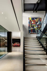 Modern floating platform concrete stairs with a colorful abstract painting above.