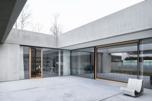Modern interior space with concrete walls and glass windows