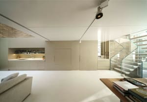 Modern interior design featuring glass, concrete, and steel elements.