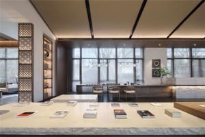 Modern minimalist home office with white and black bookshelves, wooden floor, and large windows.
