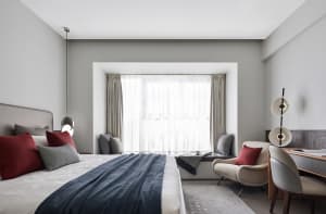 A minimalist bedroom featuring fabric, wood, and metal elements.