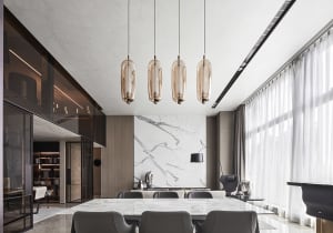 Modern dining room featuring marble, glass, and metal elements.