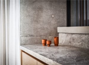 Concrete kitchen countertop with minimalist design and terracotta vessels