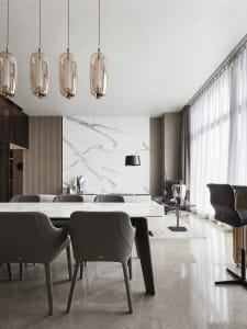 A modern living room featuring marble walls and furniture.