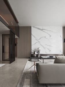 Modern living room featuring marble walls and glass furniture.
