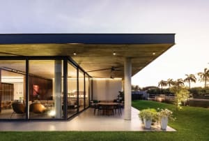 Modern residential design featuring concrete, glass, and wood materials.