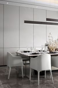 Modern dining room with white leather chairs, a marble tabletop, and a glass chandelier.