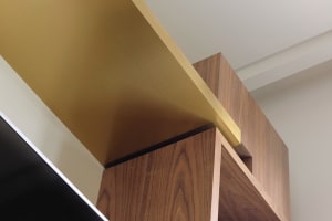 A modern-leaning room showcasing a wooden panel with a metal trim, indicating a mix of materials.