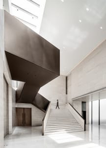 A modern lobby featuring marble and wood materials.